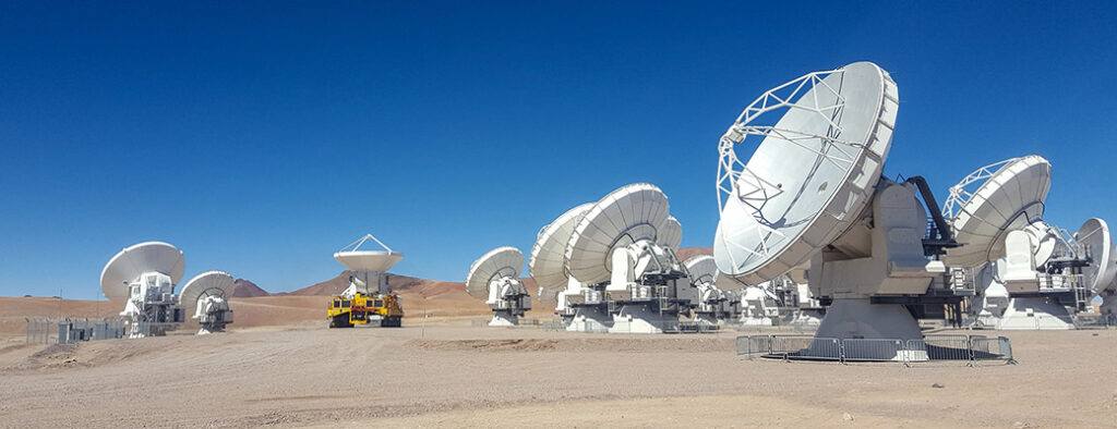 A landscape of radio telescopes in day light. Shot in Chajnandor high plateau at the ALMA radio telescopes.
