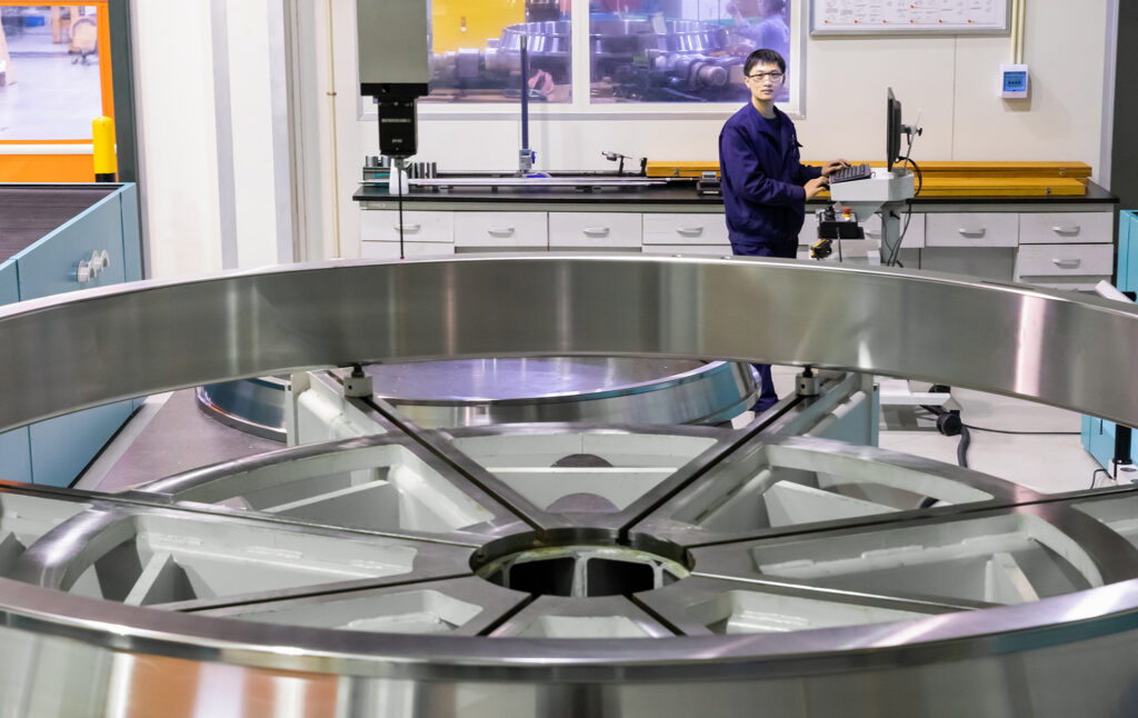Image of a TImken technician working on a very large bearing.