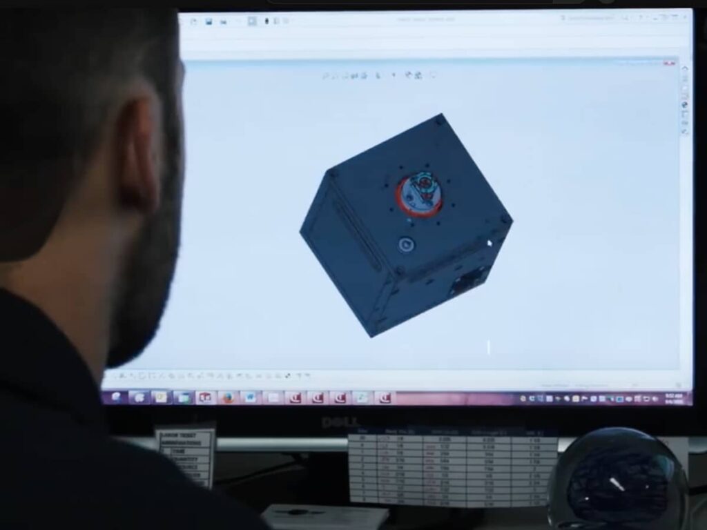 over the shoulder view of a man using software on the computer